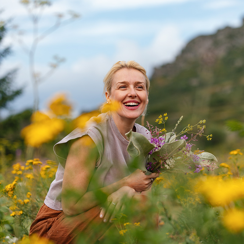 Joyful Woman Enjoying Nature in Serene Meadow Setting