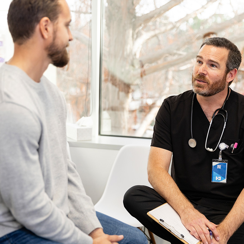 male doctor gives young man advice